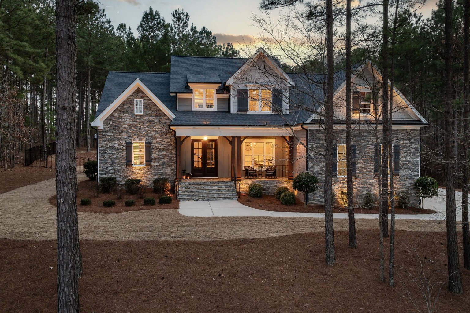 Modern stone residence in a wooded setting